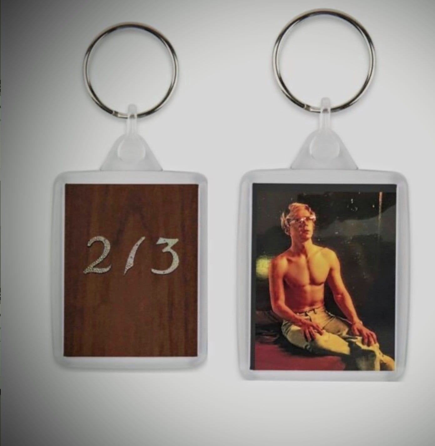 Dahmer Monster Keychain with Evan Peters sitting on the bed